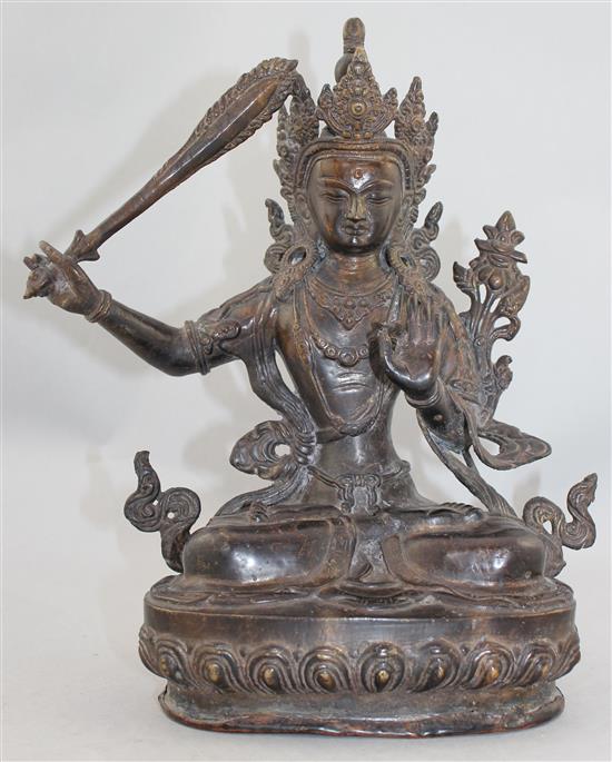 A Sino-Tibetan bronze seated figure of Manjushri, 31cm